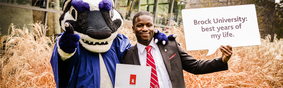 Boomer and a smiling graduate of Brock University at Convocation