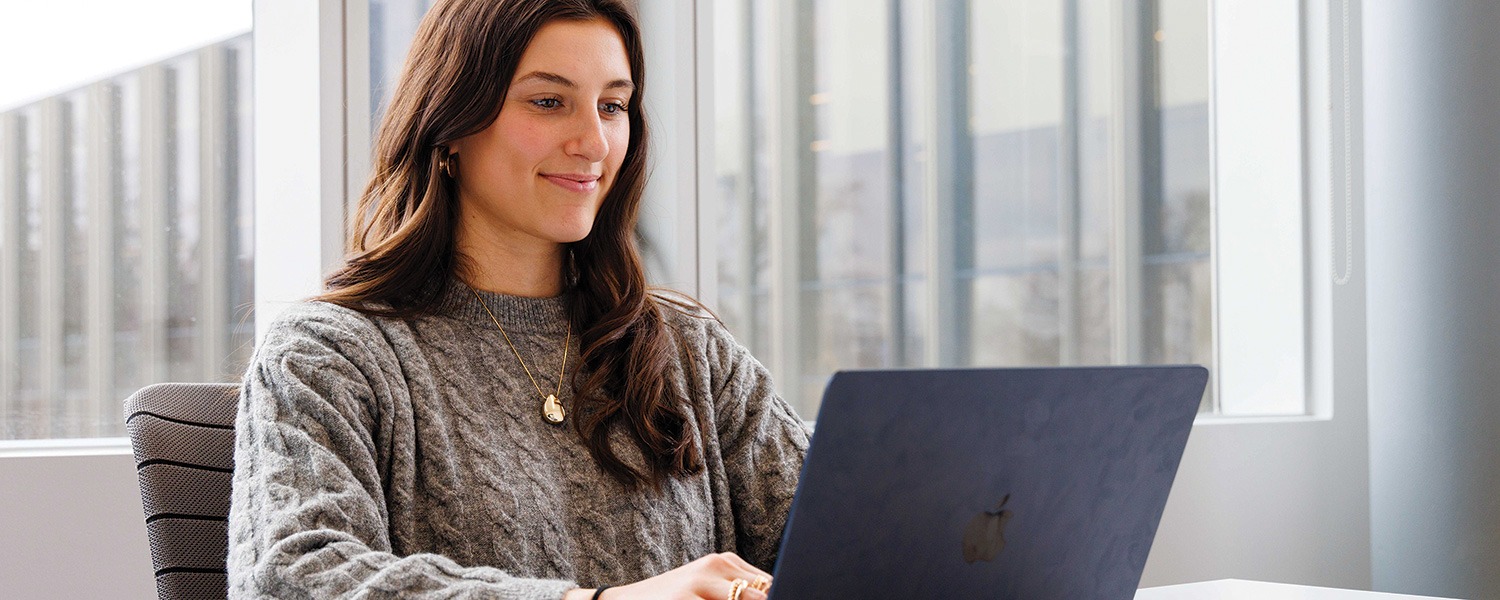 A Brock student working on their laptop