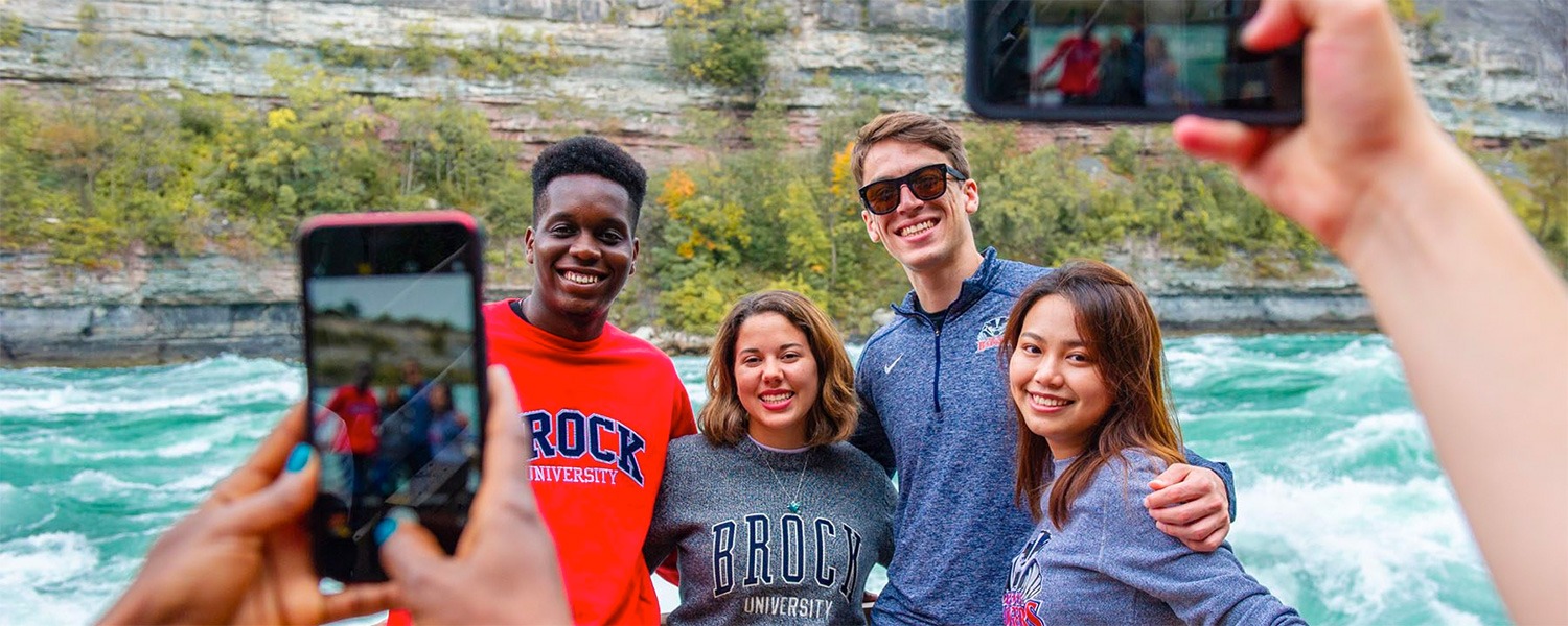 Smiling students in front of the Niagara River