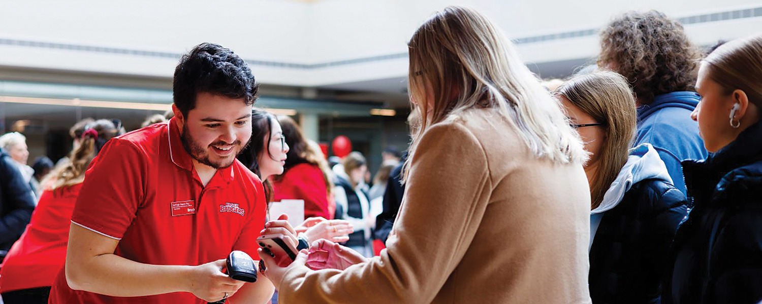 Visitors signing in at a Brock University event
