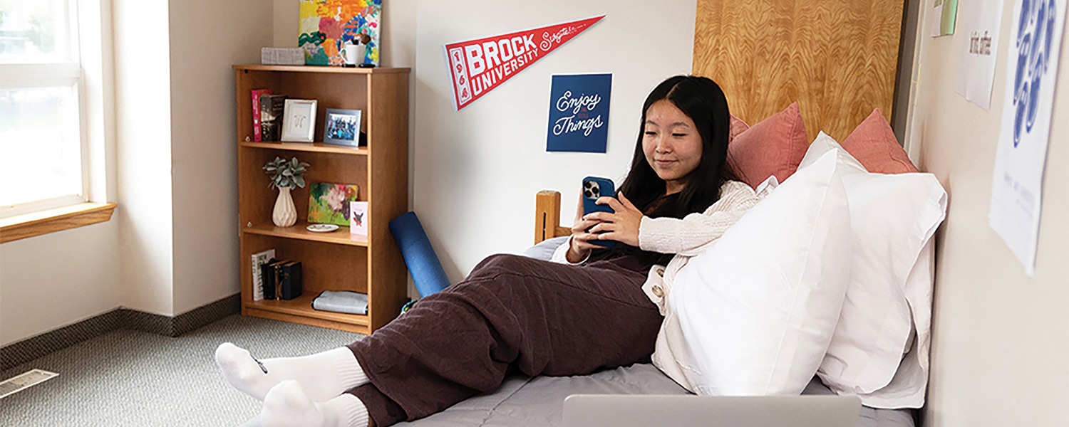 A Brock student relaxing in their residence room