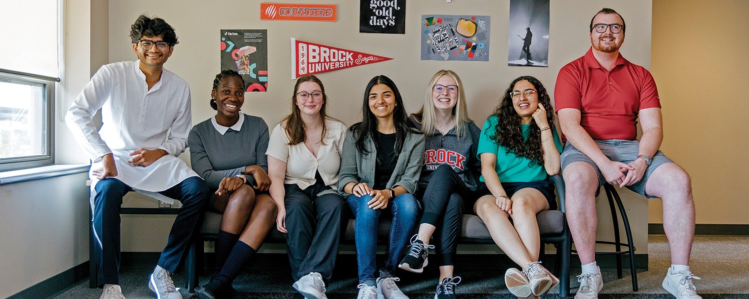 Several Brock students sitting together in a residence room
