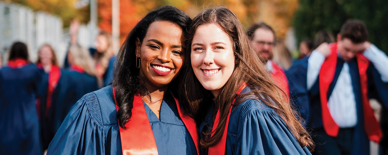 Two smiling graduates at Brock University's Convocation